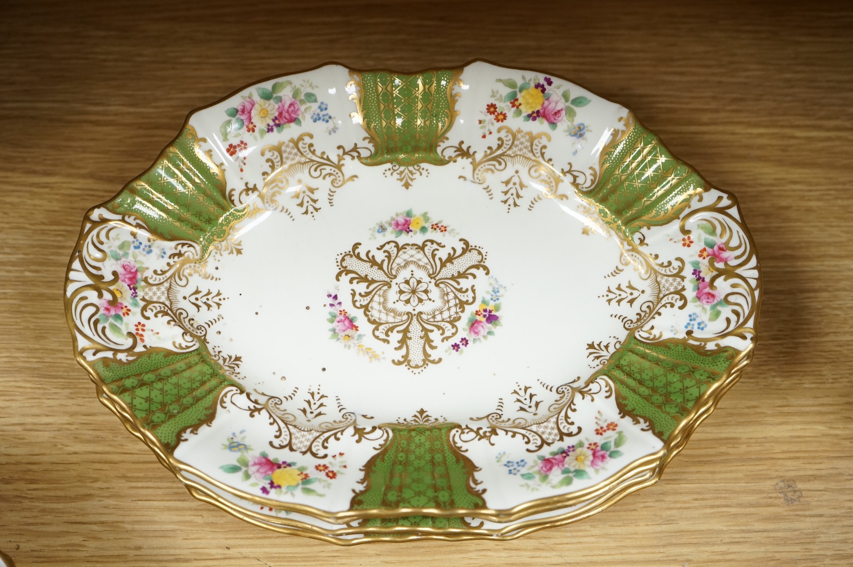 An early 20th century Wedgwood gilt and floral decorated dessert service, oval dishes 26cm wide (18).